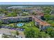 Aerial view of condo community showcasing pool, putting green, and parking at 100 S Interlachen Ave # 503, Winter Park, FL 32789