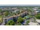 Expansive aerial view of a multi-story residential building boasting a beautiful pool, lush landscaping, and ample parking at 100 S Interlachen Ave # 503, Winter Park, FL 32789