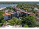 Aerial view of condominium community showcasing pool area, lush landscaping, and lakeside location at 100 S Interlachen Ave # 503, Winter Park, FL 32789