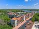 Beautiful aerial view of condominium community near lake with lush landscaping and covered parking at 100 S Interlachen Ave # 503, Winter Park, FL 32789