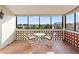 Open balcony with chairs and table, overlooking beautiful landscape and blue sky, perfect for relaxing at 100 S Interlachen Ave # 503, Winter Park, FL 32789