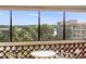 Inviting condo balcony with seating, overlooking beautiful blue water and blue sky, perfect for enjoying the outdoors at 100 S Interlachen Ave # 503, Winter Park, FL 32789