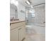 Bright bathroom featuring a vanity with a granite countertop and a glass-enclosed shower-tub at 100 S Interlachen Ave # 503, Winter Park, FL 32789