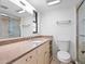 Bright bathroom features a neutral vanity with granite counters, a glass shower, and ample lighting at 100 S Interlachen Ave # 503, Winter Park, FL 32789