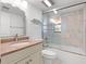Bathroom featuring a white vanity cabinet, granite countertop, and a shower-tub combo with glass doors at 100 S Interlachen Ave # 503, Winter Park, FL 32789