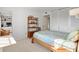 Bright bedroom with neutral carpet and bed, leading to another room through an open door at 100 S Interlachen Ave # 503, Winter Park, FL 32789