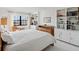 Bedroom with white walls, built-in shelving, and a window overlooking the outdoors at 100 S Interlachen Ave # 503, Winter Park, FL 32789