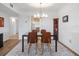 Dining area with modern chairs and a black table, features a chandelier and view to another room at 100 S Interlachen Ave # 503, Winter Park, FL 32789