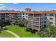 Low-rise condo with tile roof, balconies, and views overlooking the lush, green landscaping at 100 S Interlachen Ave # 503, Winter Park, FL 32789