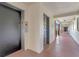 Building hallway featuring an elevator, unit doors, and an open breezeway with sunny exterior views at 100 S Interlachen Ave # 503, Winter Park, FL 32789