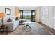 Cozy living room with comfortable seating, a glass table, and a view of the outdoor balcony at 100 S Interlachen Ave # 503, Winter Park, FL 32789
