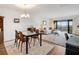 Open concept living and dining area leading to a balcony with an outside view at 100 S Interlachen Ave # 503, Winter Park, FL 32789