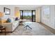 Bright living room featuring a balcony with seating that offers outdoor views and natural light at 100 S Interlachen Ave # 503, Winter Park, FL 32789