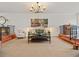 Inviting living room with neutral walls, plush seating, a dark wood coffee table, and natural light at 100 S Interlachen Ave # 503, Winter Park, FL 32789