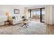 Comfortable living room with a large window wall leading to a terrace with chairs and an outside view at 100 S Interlachen Ave # 503, Winter Park, FL 32789