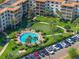 Scenic aerial shot of a sparkling pool, putting green, and luxurious landscaping at a well-appointed residential complex at 100 S Interlachen Ave # 503, Winter Park, FL 32789