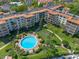 Aerial view showcasing a community pool surrounded by lush landscaping and well-maintained grounds at 100 S Interlachen Ave # 503, Winter Park, FL 32789