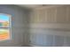 A bright bedroom under construction with fresh drywall, a large window, and ample natural light at 1013 Alabaster Way, Deltona, FL 32725