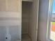 Unfinished walk-in closet with drywall walls, baseboard trim, and an open door, ready for customization at 1013 Alabaster Way, Deltona, FL 32725