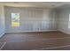 Unfinished room with stud walls, drywall, base trim and windows offering natural light at 1013 Alabaster Way, Deltona, FL 32725