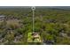 Aerial view of a secluded property surrounded by lush green trees, providing privacy and tranquility at 1120 Sheeler Ave, Apopka, FL 32703