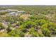 Extensive aerial view of the home's location amid mature trees in a thriving neighborhood at 1120 Sheeler Ave, Apopka, FL 32703
