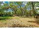 Picture of a secluded backyard with mature trees, and natural landscaping with lots of space for activities at 1120 Sheeler Ave, Apopka, FL 32703