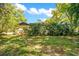 Well-maintained backyard featuring lush greenery, mature trees, and a private setting at 1120 Sheeler Ave, Apopka, FL 32703