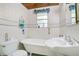 Bathroom with a bathtub, sink, and floral wallpaper at 1120 Sheeler Ave, Apopka, FL 32703