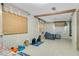 Cozy bedroom with wood-look walls, tile floors, and plenty of natural light at 1120 Sheeler Ave, Apopka, FL 32703