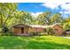 Charming single-story brick home with a well-manicured lawn and mature trees in a peaceful residential neighborhood at 1120 Sheeler Ave, Apopka, FL 32703