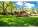 Charming single-story brick home with a well-manicured lawn and mature trees in a peaceful residential neighborhood at 1120 Sheeler Ave, Apopka, FL 32703