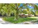 Property view showcasing a lush green lawn, mature trees, and appealing brick home exterior at 1120 Sheeler Ave, Apopka, FL 32703