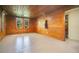 Living room featuring wood paneled walls and a tile floor at 1120 Sheeler Ave, Apopka, FL 32703