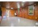 Living room featuring wood paneled walls and a tile floor at 1120 Sheeler Ave, Apopka, FL 32703