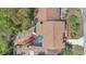 An aerial view shows the home's roof, landscaping, and screened-in porch at 122 Spreading Oak Ct, Sanford, FL 32773