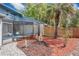 Backyard featuring landscaping and a screened patio at 122 Spreading Oak Ct, Sanford, FL 32773