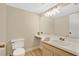 Well-lit bathroom with a single sink vanity, neutral walls, and a large frameless mirror at 122 Spreading Oak Ct, Sanford, FL 32773