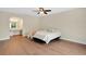 Bright bedroom featuring a bed, ceiling fan, and wood-look flooring at 122 Spreading Oak Ct, Sanford, FL 32773