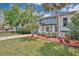Beautiful exterior shot of home with charming landscaping and blue siding on a sunny day at 122 Spreading Oak Ct, Sanford, FL 32773