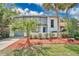 Charming two-story home with palm trees and well-maintained landscaping in a sunny, bright shot at 122 Spreading Oak Ct, Sanford, FL 32773