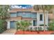 Inviting two-story home featuring a well-manicured front yard with lovely palm trees at 122 Spreading Oak Ct, Sanford, FL 32773