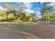 Wide open green park with picnic tables and covered pavilions surrounded by mature trees on a sunny day at 122 Spreading Oak Ct, Sanford, FL 32773