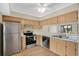 Bright kitchen featuring stainless steel appliances, sleek countertops, and ample cabinet space at 122 Spreading Oak Ct, Sanford, FL 32773