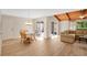 Inviting living area with wood-look floors and lots of natural light through sliding glass doors at 122 Spreading Oak Ct, Sanford, FL 32773