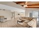Bright living room featuring a beamed wood ceiling and an oversized sectional sofa at 122 Spreading Oak Ct, Sanford, FL 32773