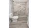 Modern bathroom featuring gray-patterned tiled shower and gray wood flooring, combining style and functionality at 1350 Martin Luther King Jr Blvd, Bartow, FL 33830