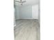 Sunlit bedroom showcasing sleek gray wood flooring and a neutral color palette for a calming atmosphere at 1350 Martin Luther King Jr Blvd, Bartow, FL 33830
