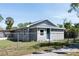 Charming single-story home featuring light gray siding, fenced yard, and a welcoming blue front door at 1350 Martin Luther King Jr Blvd, Bartow, FL 33830
