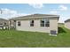 Home's backyard features a well-maintained lawn, a patio, and the exterior of the house at 1355 Wood Line Loop, Deland, FL 32720